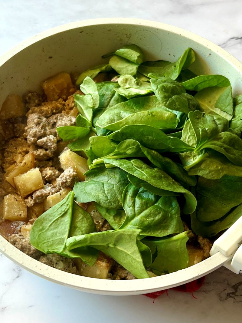 Ground beef combined with potatoes, half and half, chicken broth, and spinach.