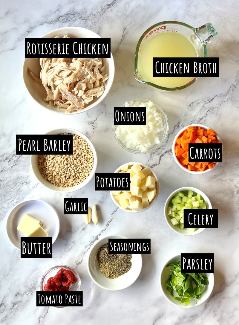 Ingredients displayed for chicken barley soup. Rotisserie chicken, chicken broth, onions, carrots, celery, garlic, pearl barley, potatoes, butter, seasonings, parsley, and tomato paste.