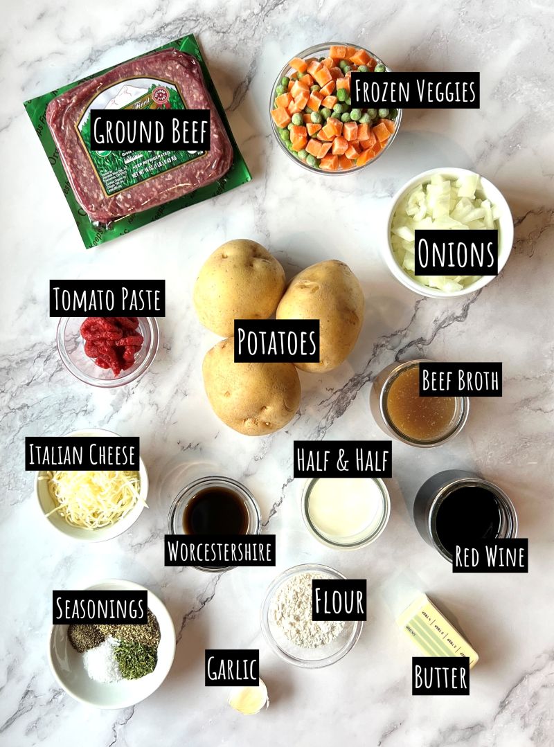 Ingredients displayed for shepherd's pie. Ground beef, frozen peas and carrots, onions, yellow potatoes, tomato paste, half and half, Italian cheese, Worcestershire, beef broth, red wine, flour, butter, seasonings, and garlic.  