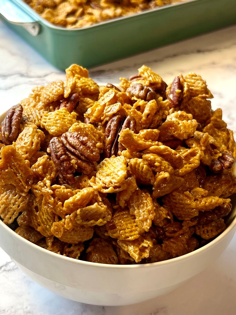 A bowl with baked maple pecan snack mix.