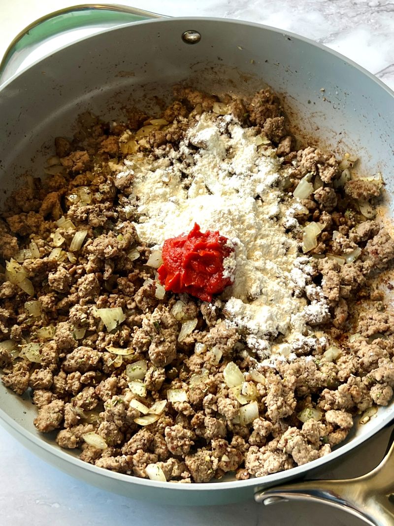 Flour and tomato paste mixed with cooked ground beef.