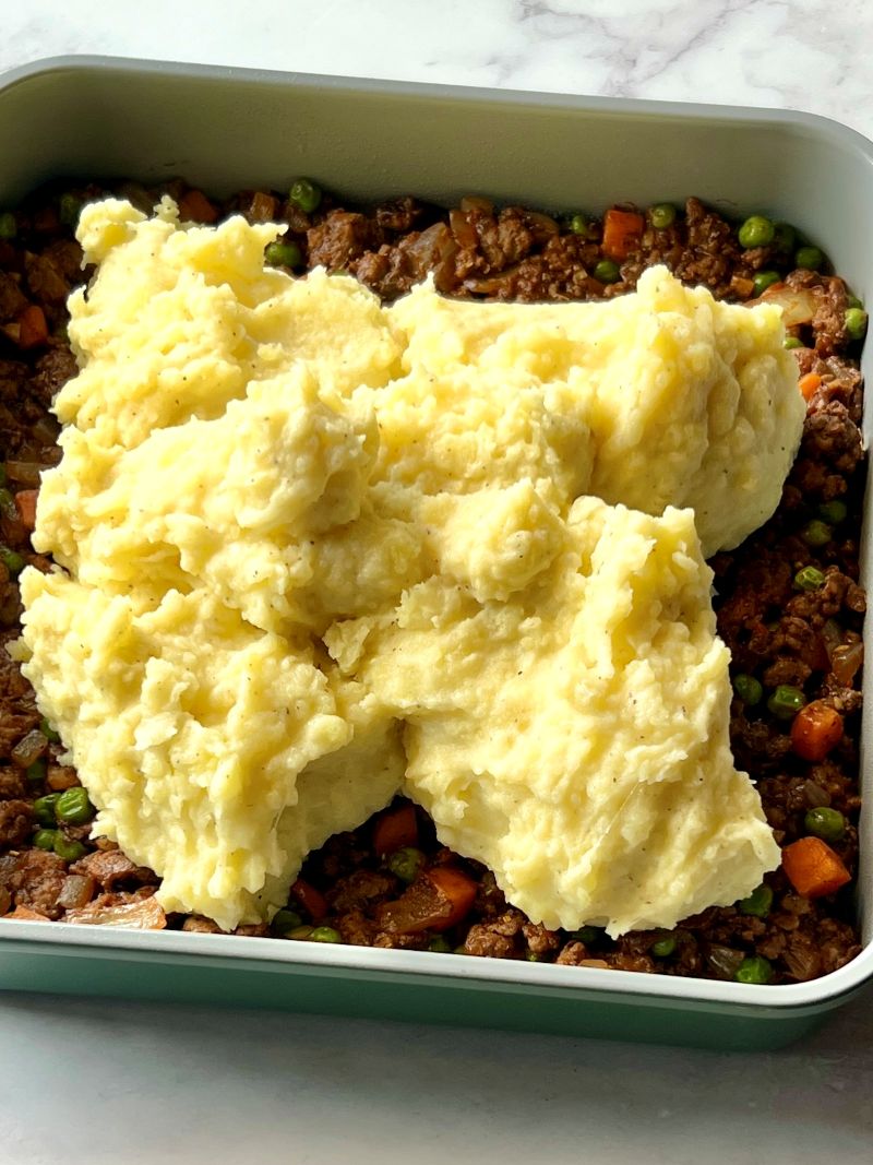Meat mixture spread in baking dish and topped with mashed potatoes. 