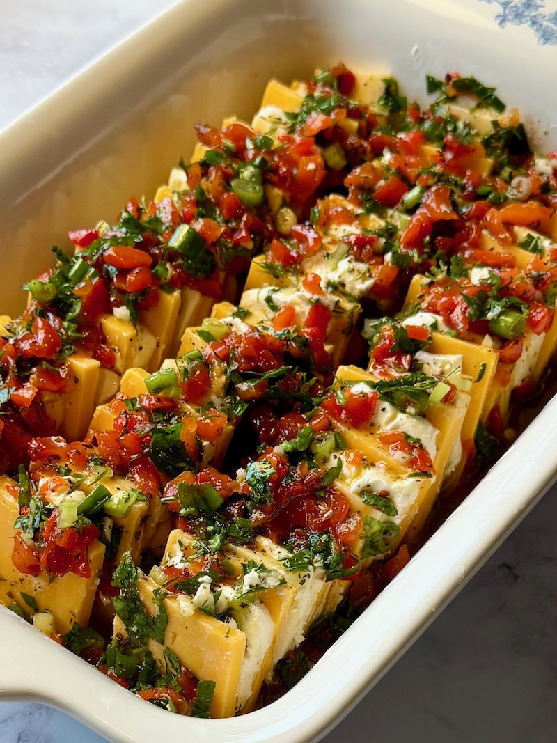 Marinade poured over the layered cheese.