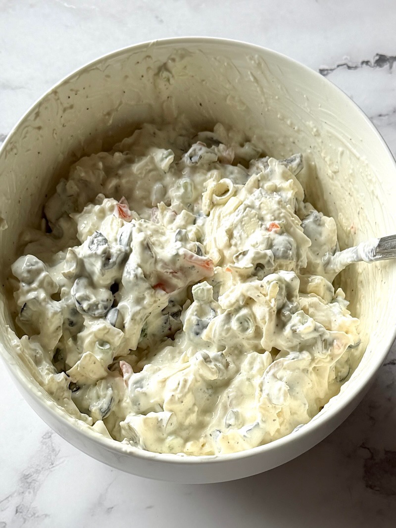 Cheese and olive spread mixed in a bowl.