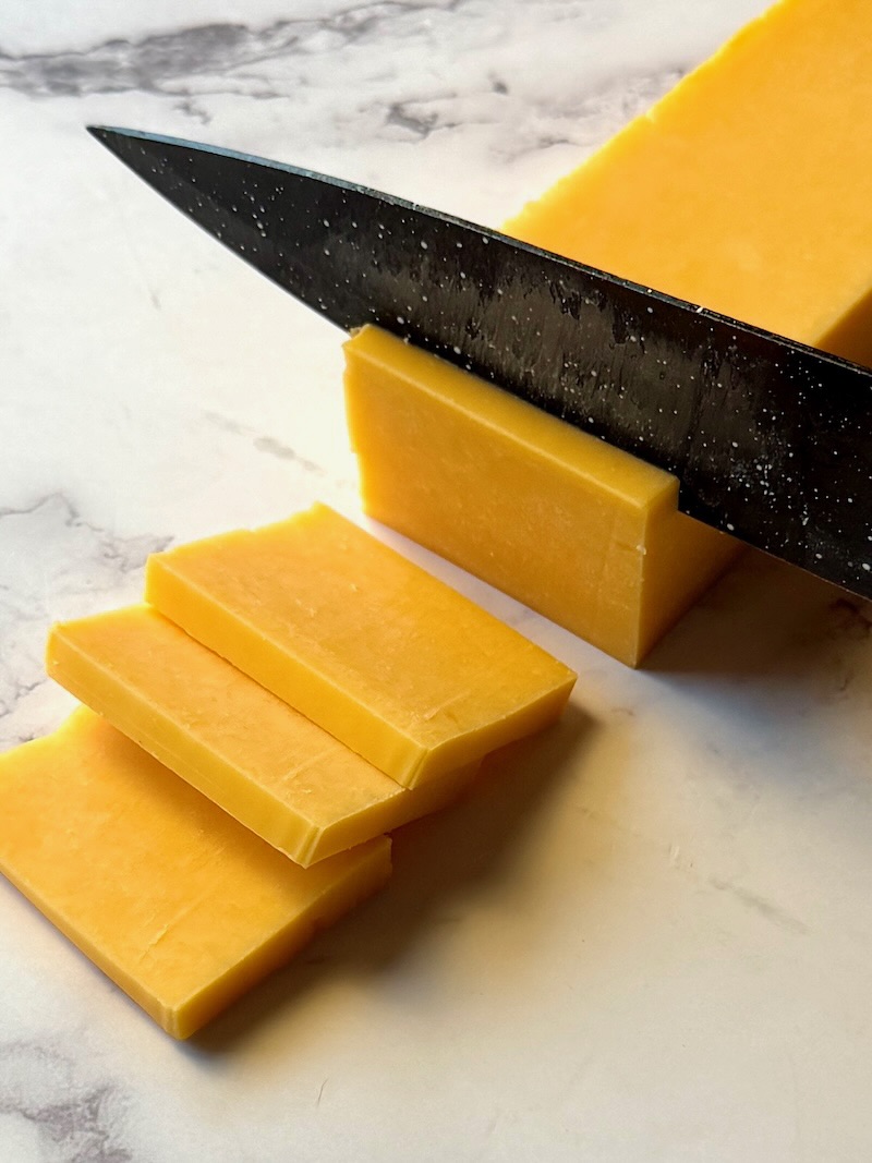 Demonstration of cheddar cheese slices.