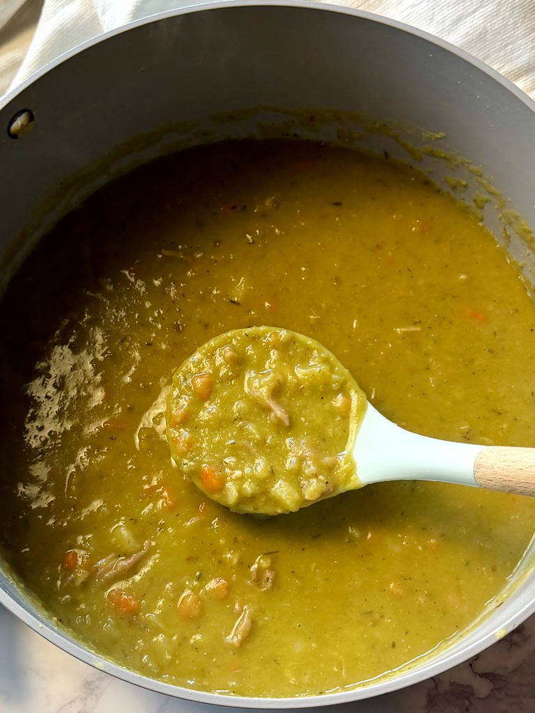 Pot of split pea soup with a ladle.