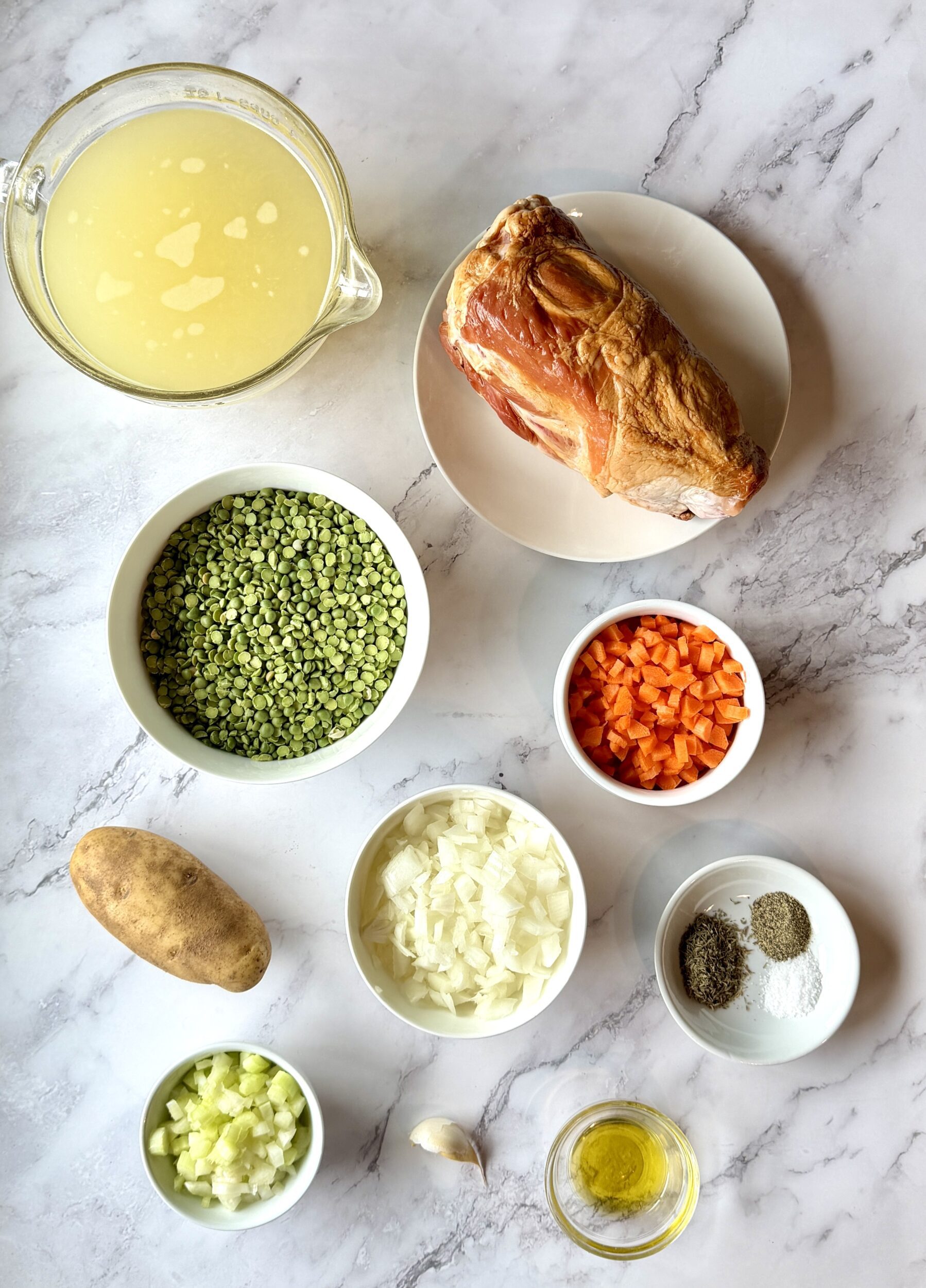 Ingredients for split pea soup and ham include split green peas, ham shank, chicken broth, onions, garlic, celery, carrots, potatoes, seasonings, and olive oil.