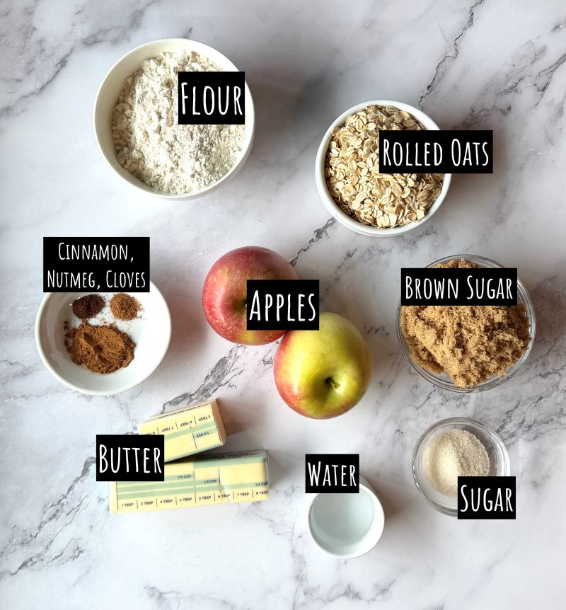 Ingredients displayed for Apple pie bites. Flour, rolled oats, brown sugar, butter, cinnamon, nutmeg, cloves, apples, water, and sugar.