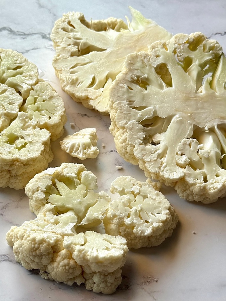 Raw cauliflower cut in 1 inch slices.
