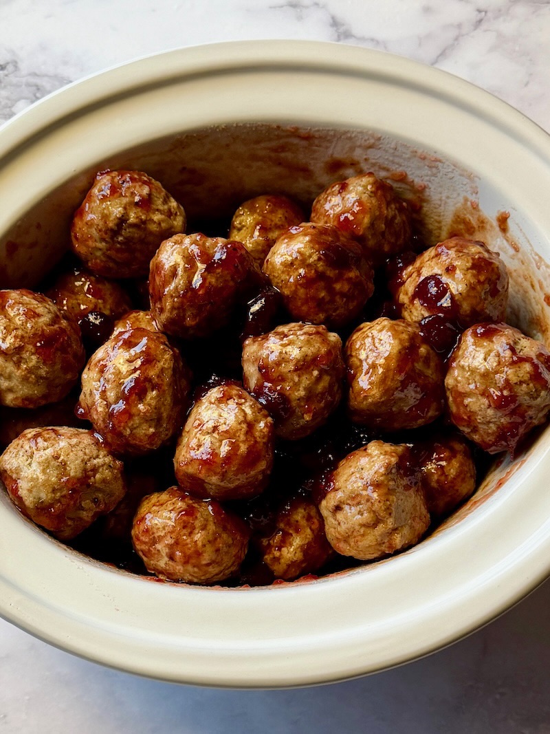 Frozen meatballs in a slow combined with cranberry sauce, brown sugar, and BBQ sauce. 