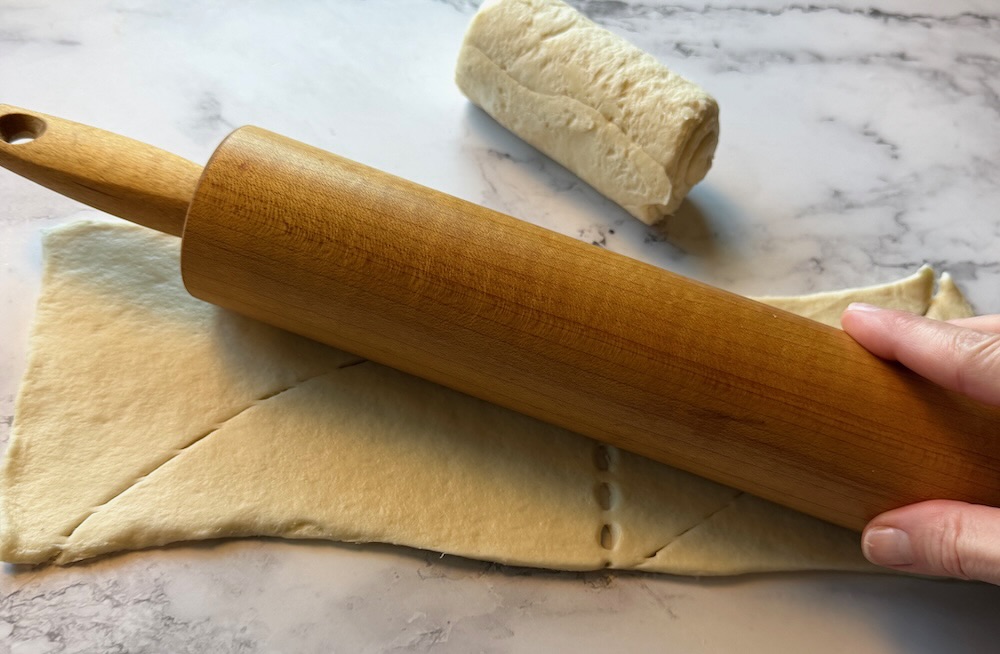 Crescent dough rolled out with a rolling pin.
