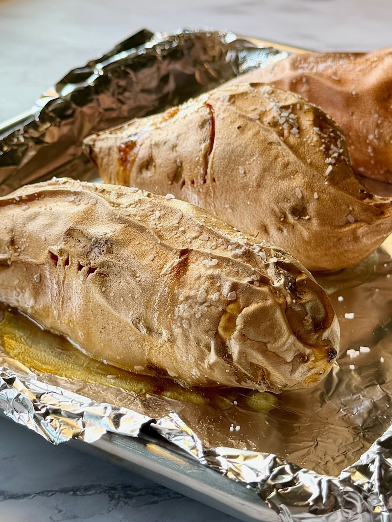 Sweet potatoes baked on a sheet pan with olive oil and salt. 