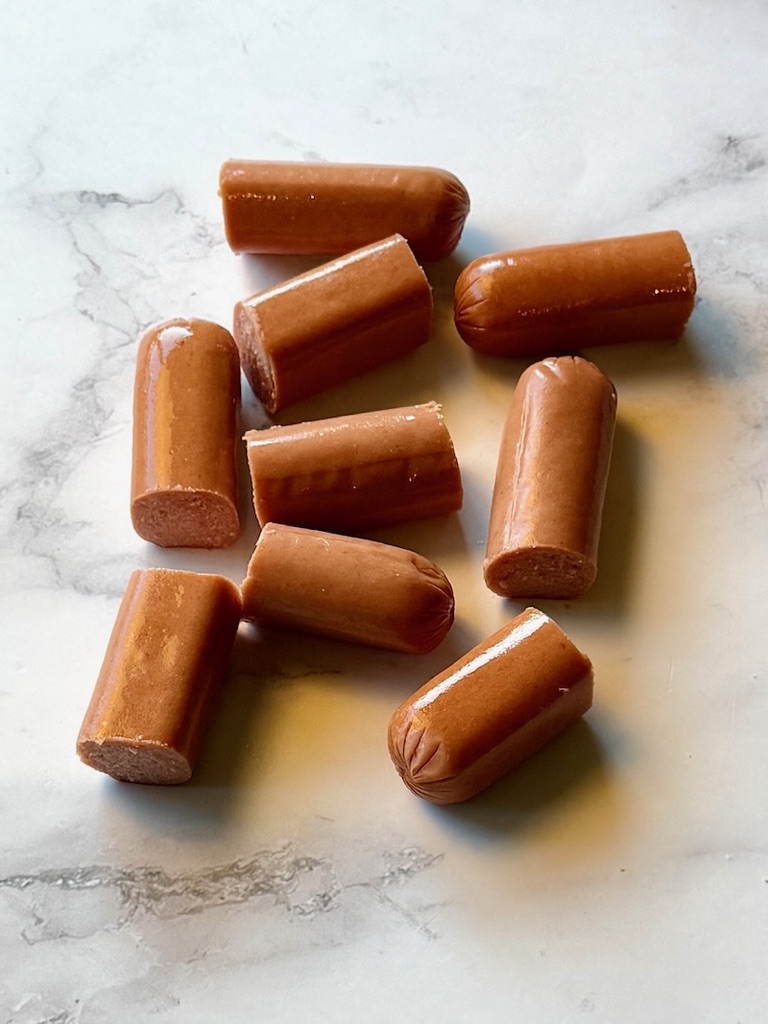 Hotdogs cut in thirds.