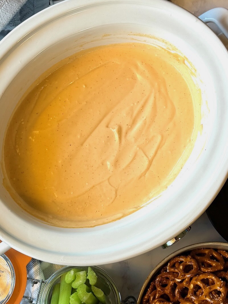 Cooked and melted slow cooker beer cheese. 