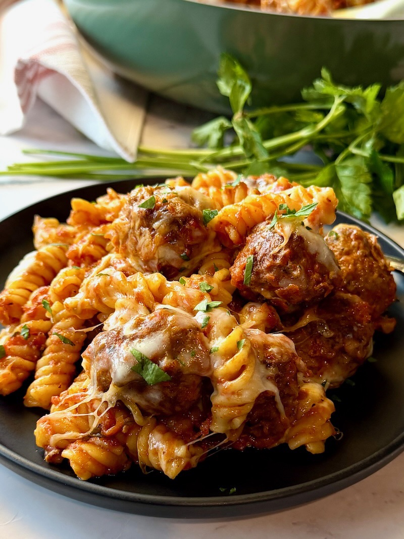 A serving plate with Italian meatballs casserole.