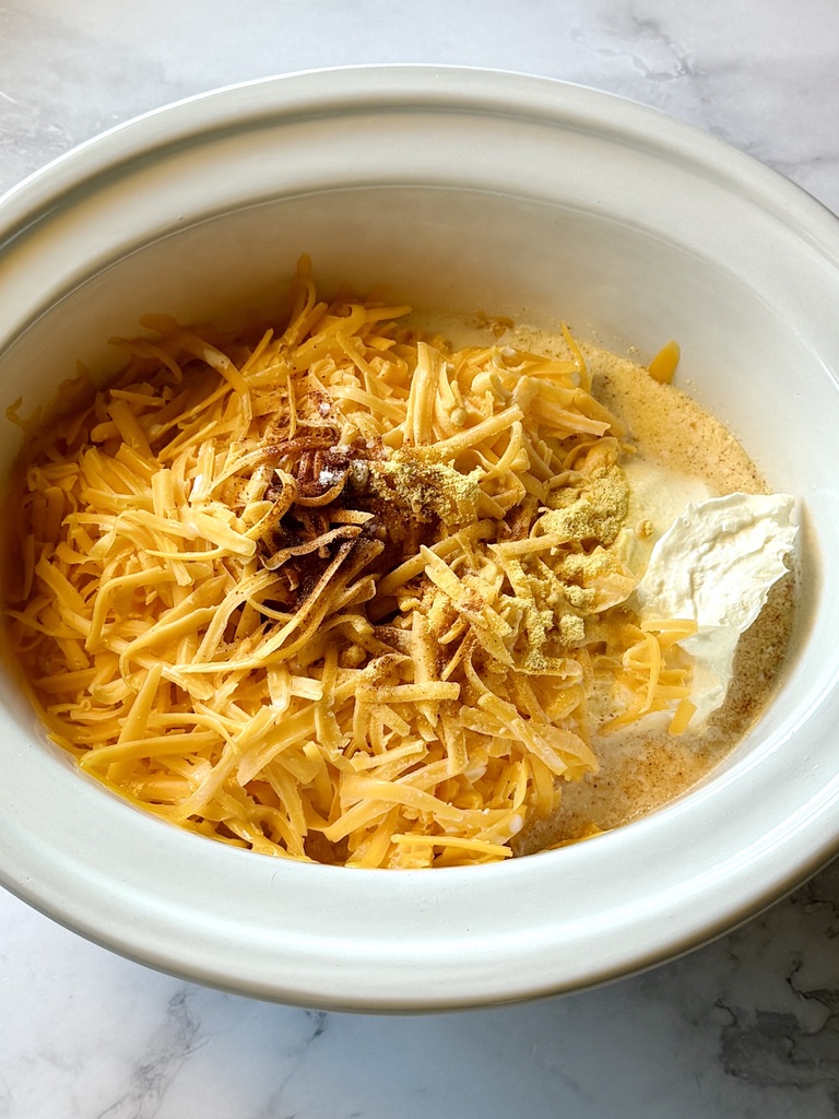 Beer cheese ingredients in the slow cooker. 