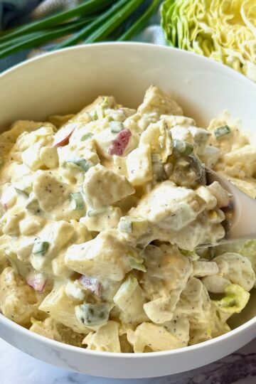 A serving bowl with Irish Potato Salad with Cabbage.