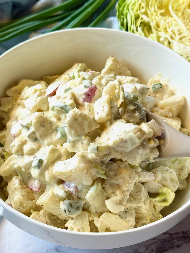 A serving bowl with Irish Potato Salad with Cabbage.