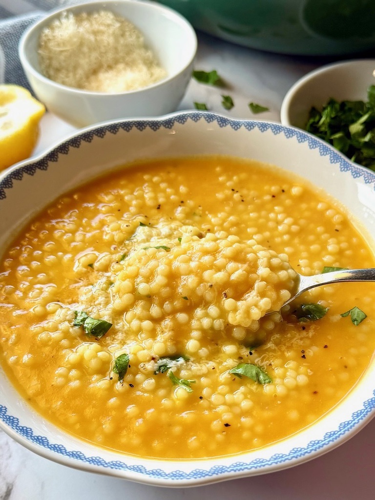 bowl of Italian penicillin soup with parmesan cheese, parsley, and lemon juice. 