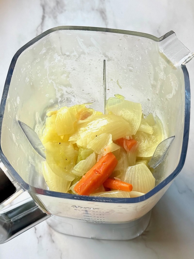 Cooked veggies in a blender with water.