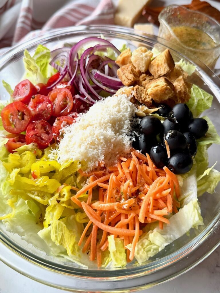 Olive garden salad ingredients in a serving bowl