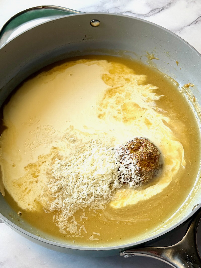heavy cream, honey, mustard, and parmesan cheese added to the thickened broth.