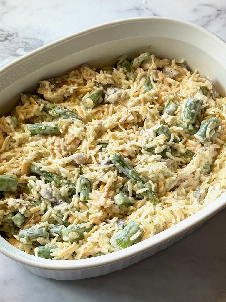 Asparagus and rice mixture spread in a casserole dish. 