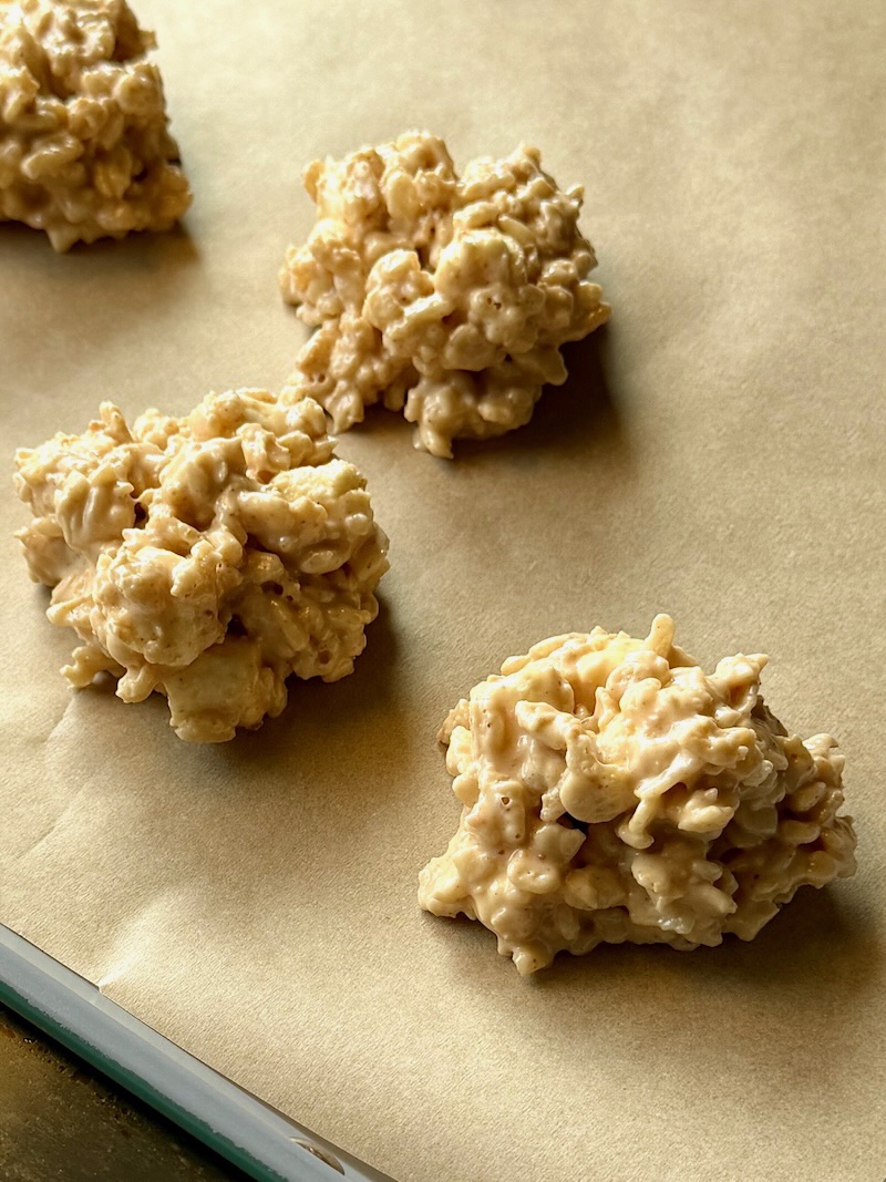 Avalanche cookies formed on a sheet pan with parchment paper. 