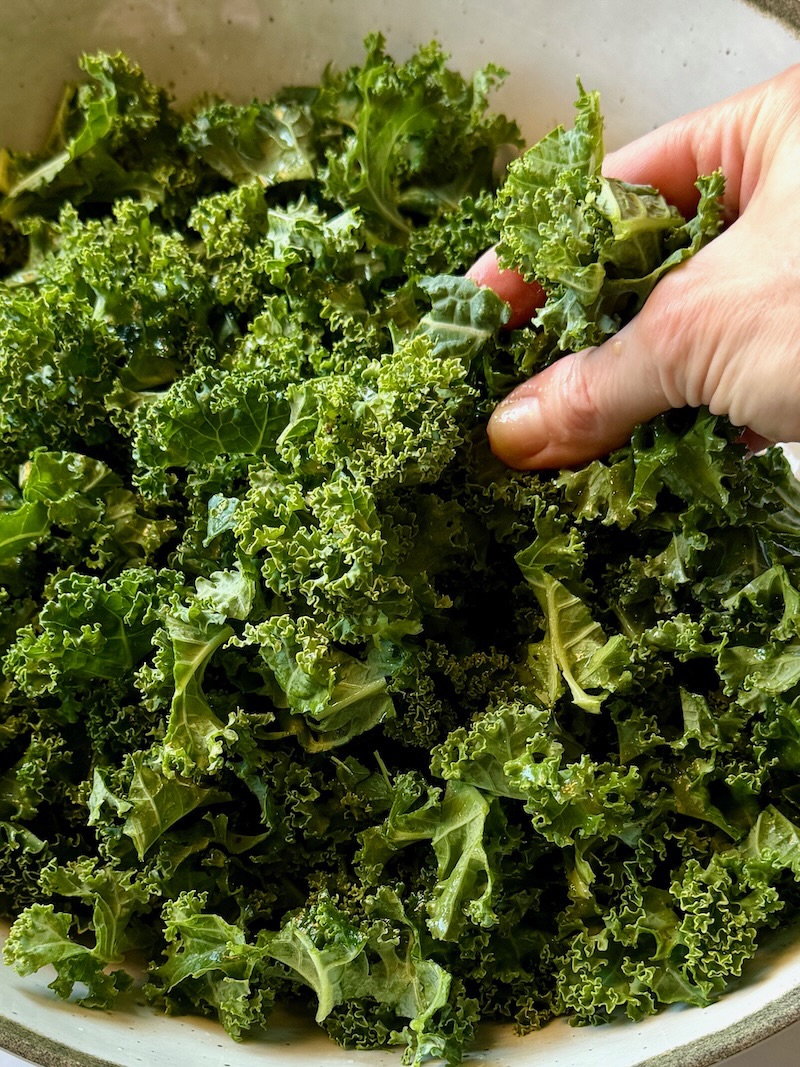 Massaging the kale with my clean hands and some of the dressing. 