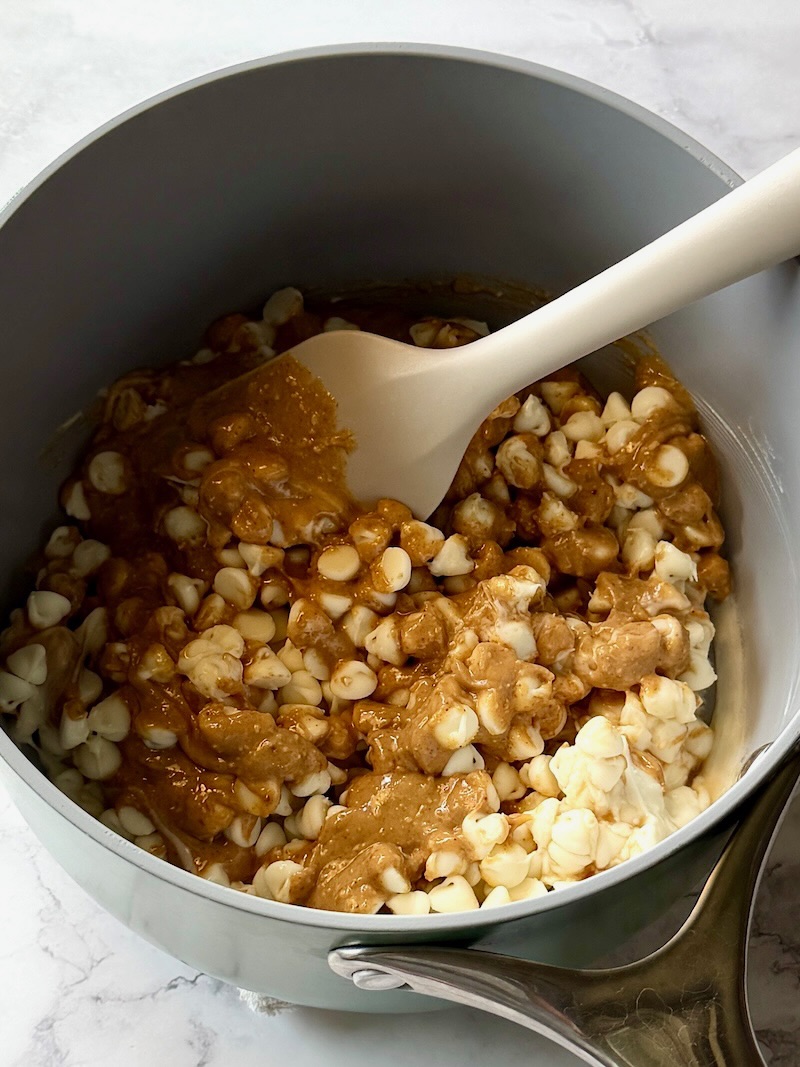 white chocolate chips, peanut butter, and vanilla extract in a saucepan.