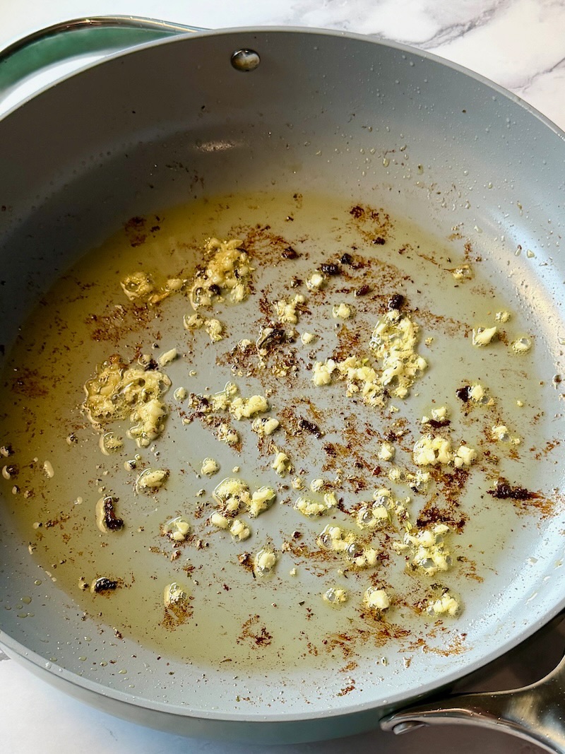 Fresh garlic sautéed in a skillet. 