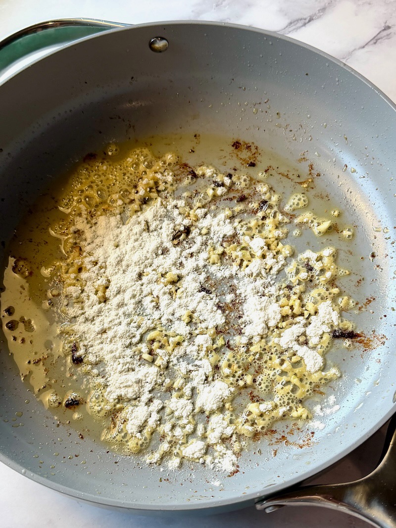 Flour added to the skillet with the garlic to thicken the sauce.
