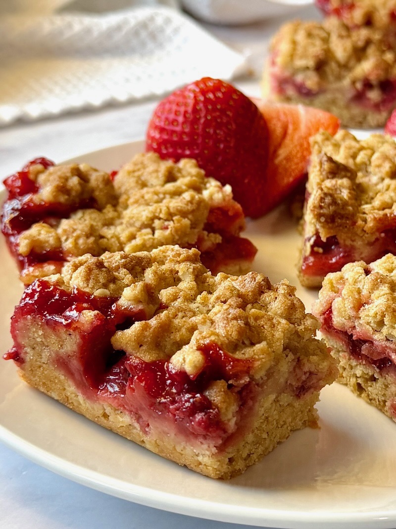 Strawberry bars cut in squares on a plate. 