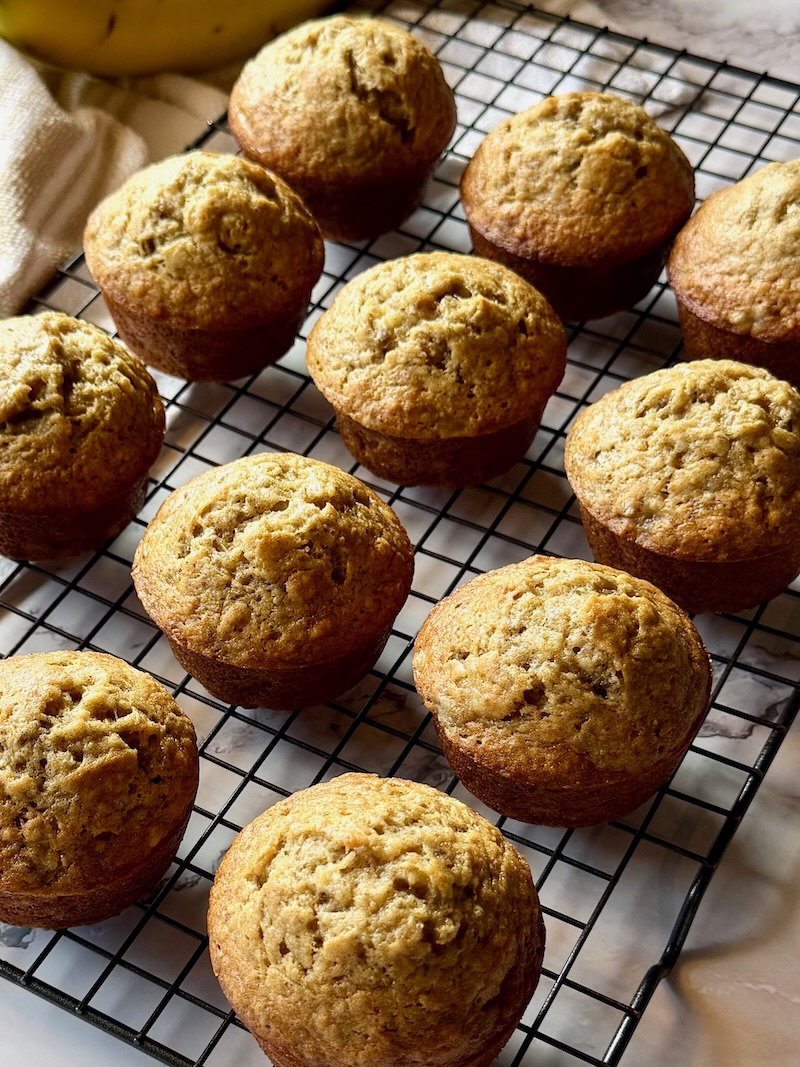 fluffy banana muffins on a cooling rack.