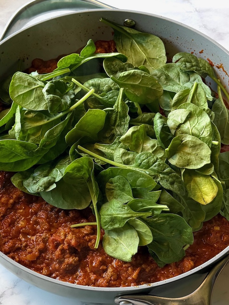 Baby spinach added to to the meat sauce. 