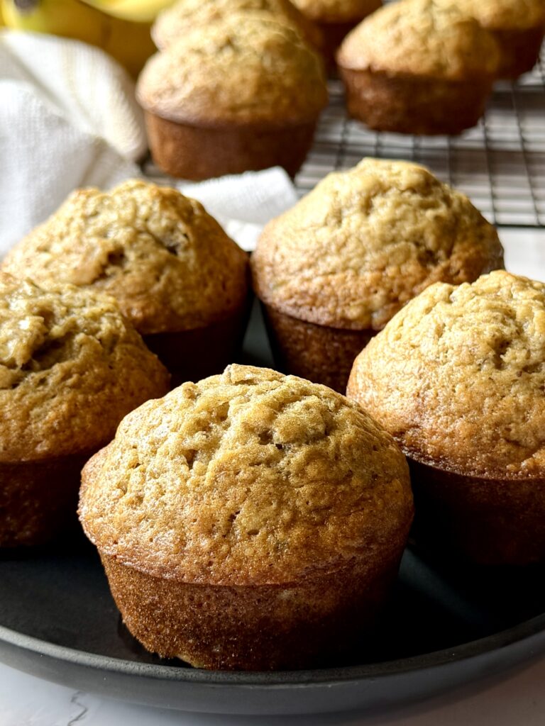 easy fluffy banana muffins on a plate.