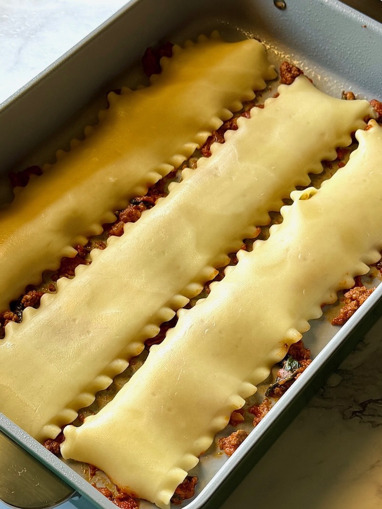 3 Cooked lasagna noodles on the bottom of the baking dish