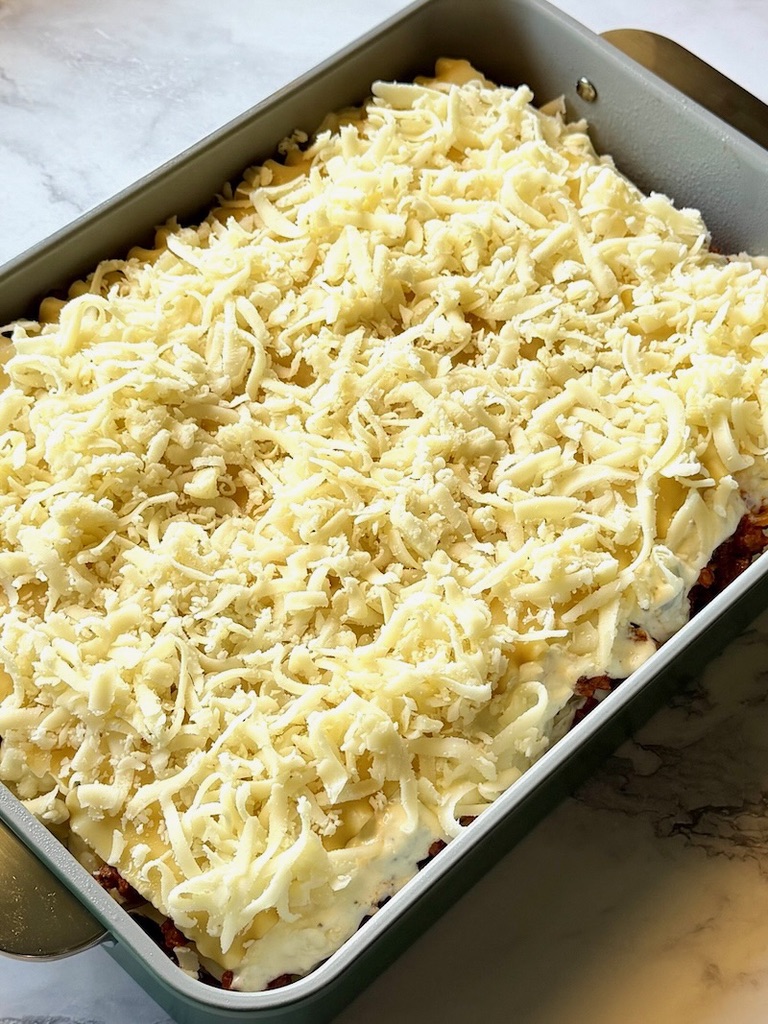 Layered sour cream lasagna with cheese on top