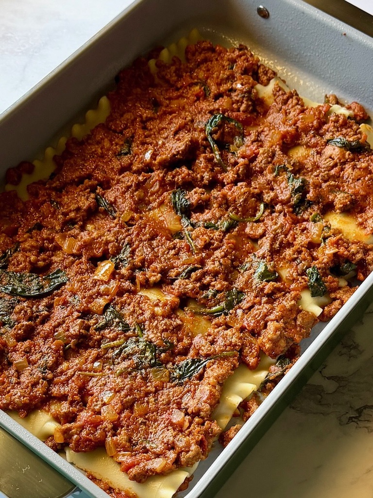 Meat sauce on top of cooked lasagna sheets