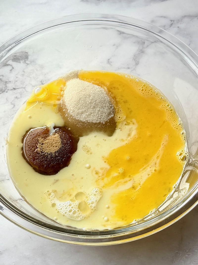 oil, sugars, milk, vanilla extract, and eggs mixed with banana. 