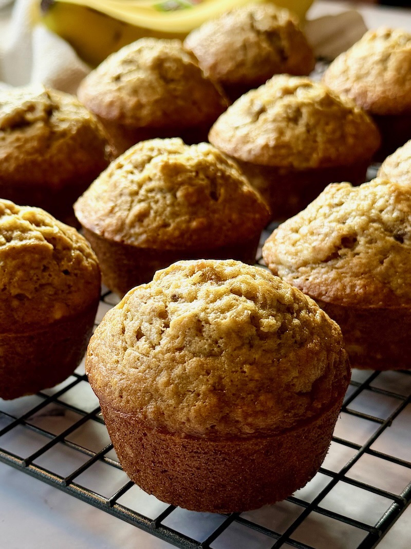 Close up of fluffy banana muffins on a cooling rack