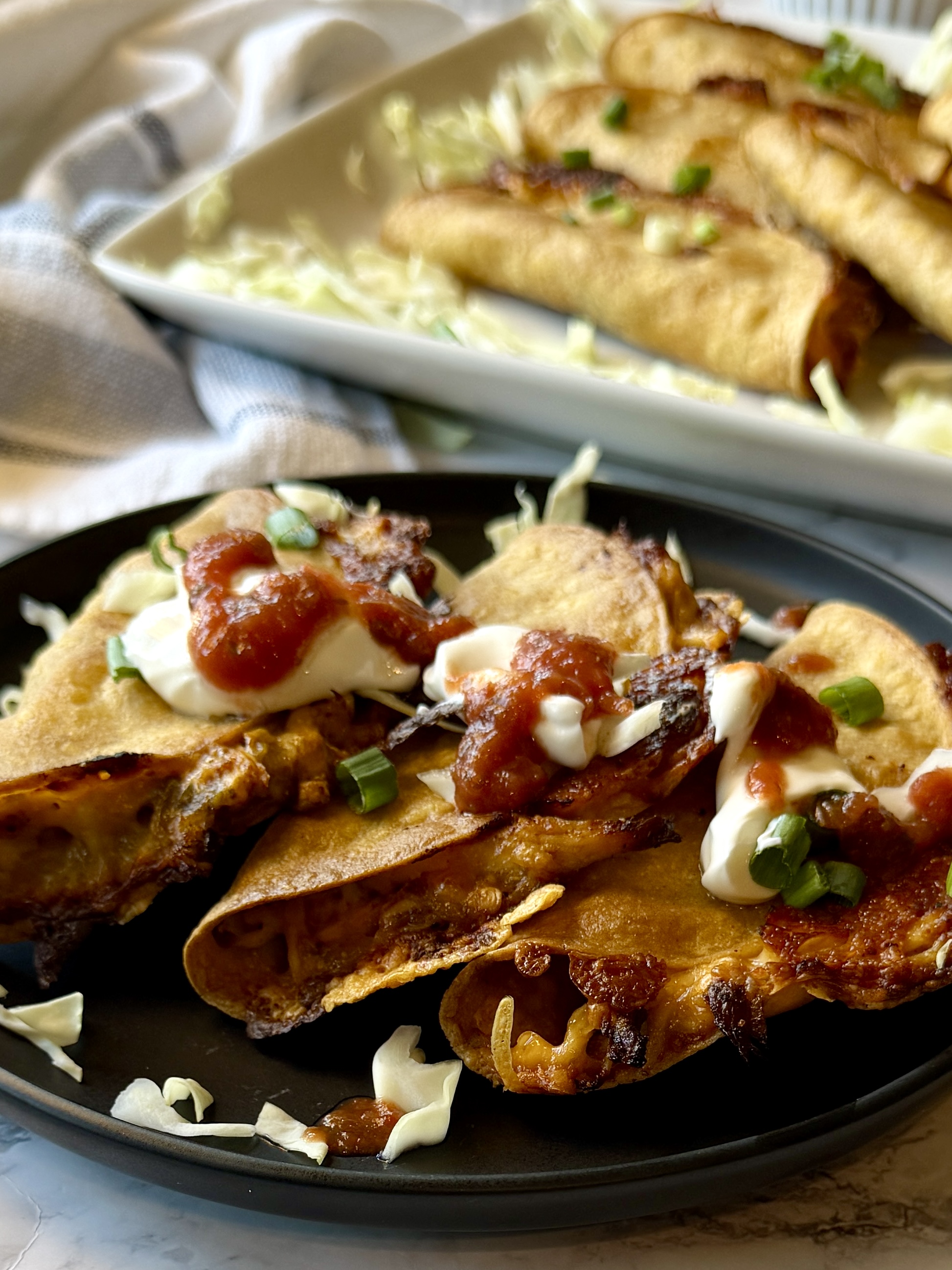 Chicken tacos served with salsa and sour cream