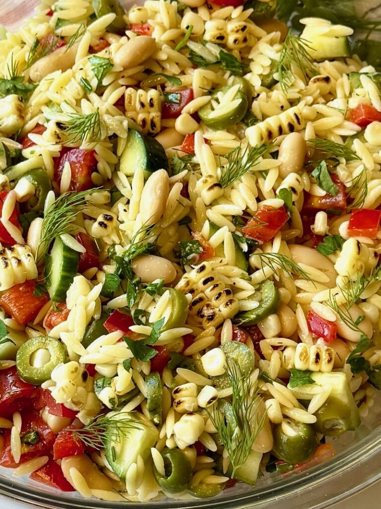Summer glow orzo salad in a serving bowl.