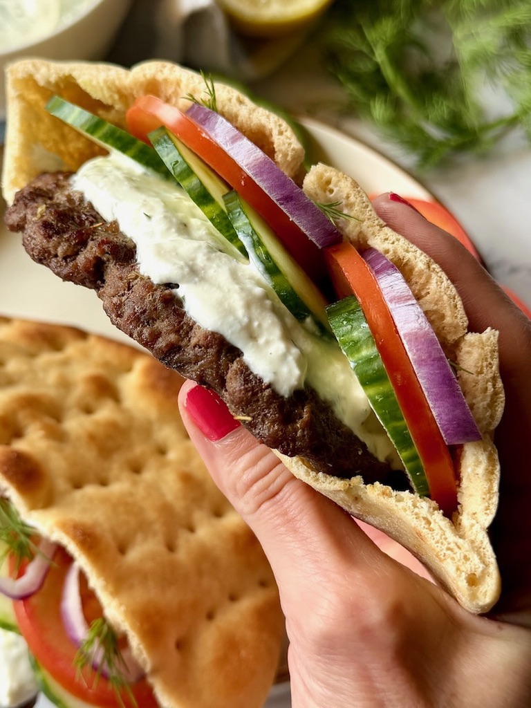 Holding one of the pita burgers.