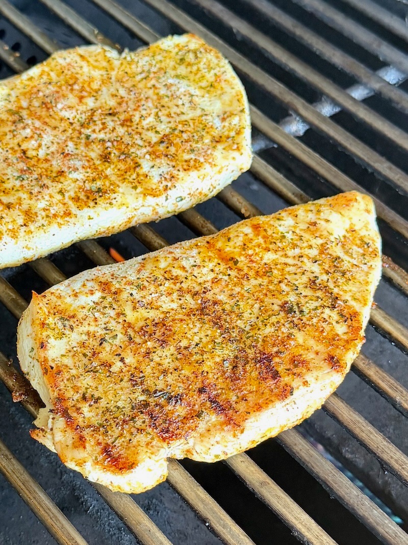 Chicken breasts on a grill.