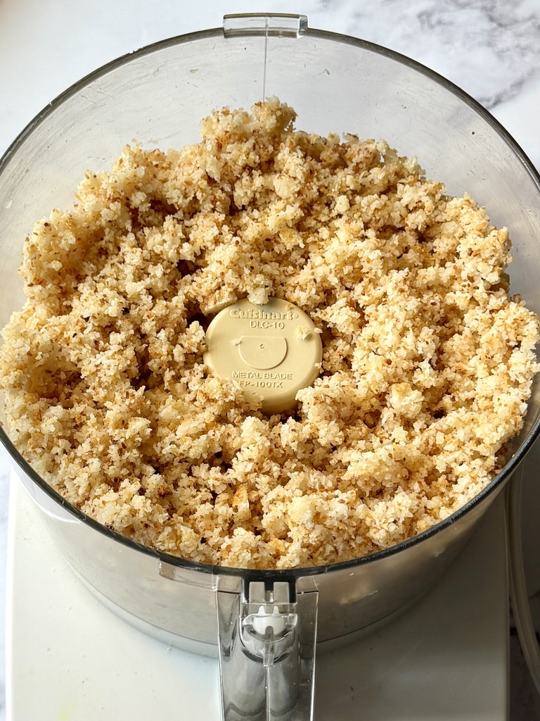Macaroons in a food processor blended into crumbles. 