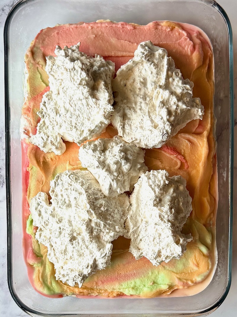 Final layer of whipped cream cookie mixture over ice cream. 