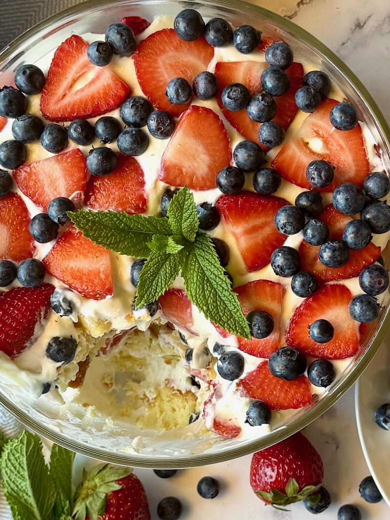 A view from the top of the trifle with a portion of dessert takin out of the center to see the inside layers.
