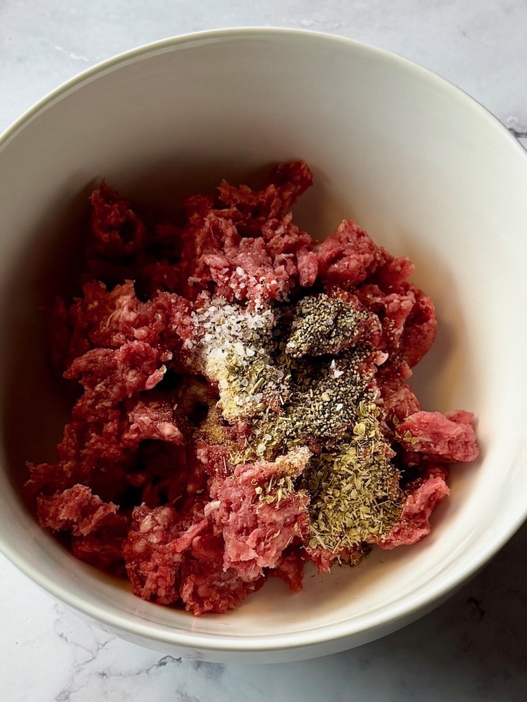 ground beef and seasonings in a bowl.