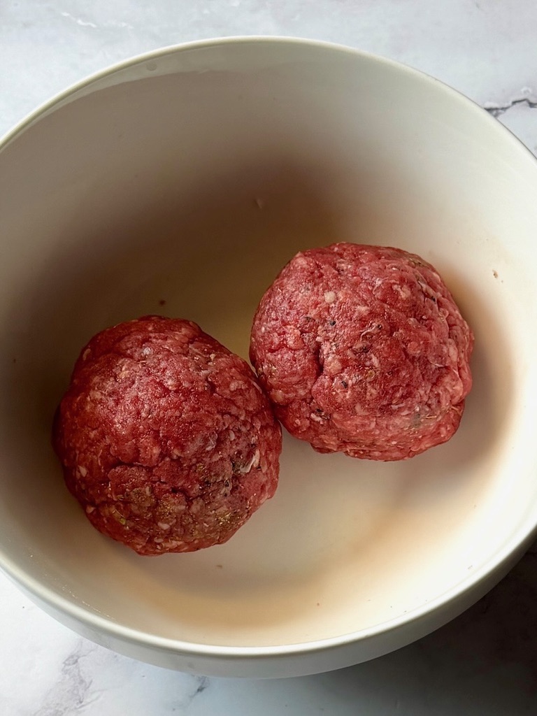ground beef mixture formed into two balls.